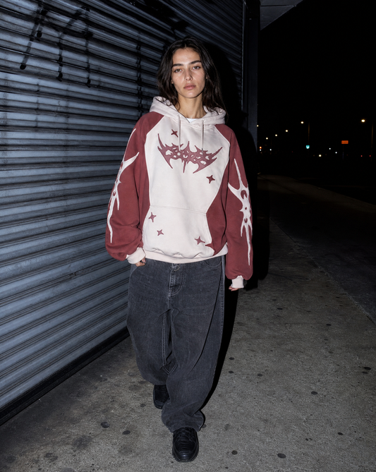 Model in a grunge pullover under direct flash beside a corrugated metal shutter