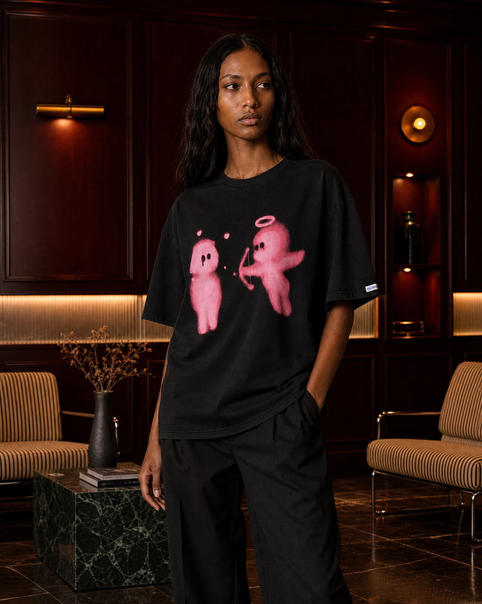 Model wearing the Cupid Arrow Tee in a dark wood-panelled lounge - editorial