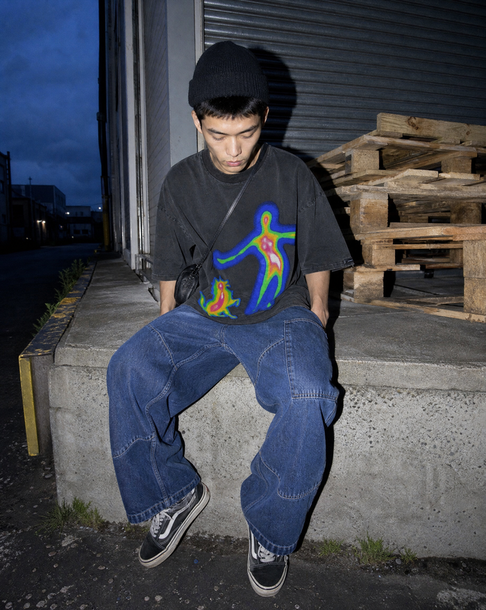 Distorted Portrait Tee worn on a loading bay